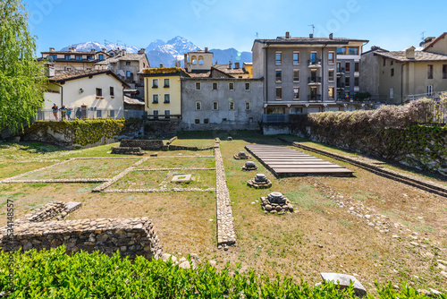 Aosta, Italy. View of the archaeological area of the ruins of the ancient Roman Theater. In the background some houses of the town. April 17, 2022.
