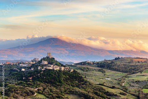 View over Castiglione d'Orcia in evening light in the Val d'Orcia in Tuscany, Italy, with Monte Amiata in the background..