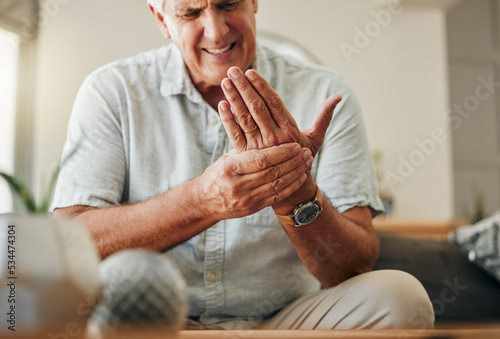 Senior man, hands and wrist joint pain in living room home from carpal tunnel, osteoporosis and arthritis. Elderly, sick and stress male, orthopedic muscle injury and fibromyalgia health risk problem