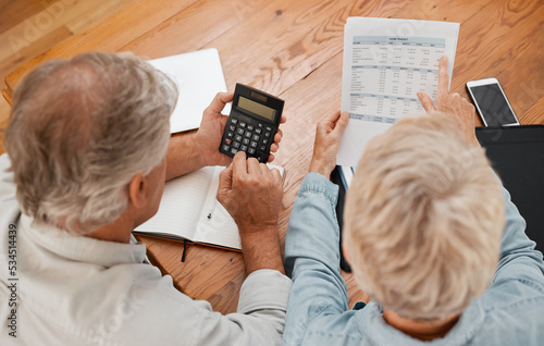 Budget, finance and senior couple with calculator planning financial investments, mortgage and tax papers. Elderly woman counting bills, debt and pension fund on bank statement with partner at home