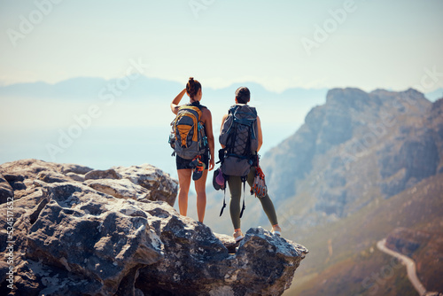 Nature, travel and hiking friends on mountain landscape with fitness, wellness and workout in summer. Freedom, rock sport or couple with backpack, health and sports exercise or training