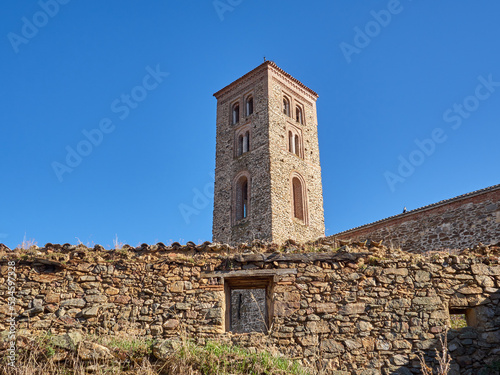 Bell Tower of Santa Maria del Castillo church behind a stone wall with a window. Buitrago del Lozoya, Community of Madrid, Spain, Europe