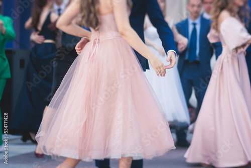 High school graduates dancing waltz and classical ball dance in dresses and suits on school prom graduation, classical ballroom dancers dancing, waltz, quadrille and polonaise