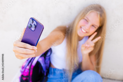 Teenage girl taking selfie with mobile phone