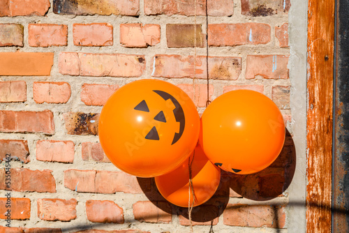 Spooky halloween balloons hanging on a brick wall