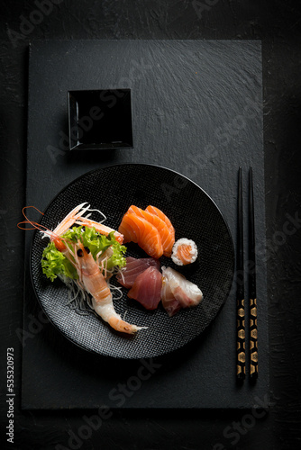 mix sashimi over black dish