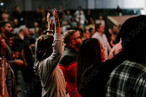 Hands in the air of people who praise God at church service