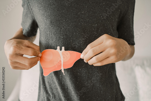 Man holding liver, hepatitis vaccination, liver cancer treatment, world hepatitis day