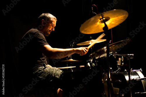 Drummer in rock band recording music in the professional recording studio