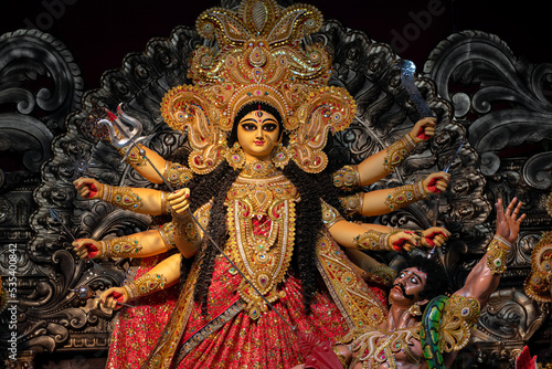 Idol of Goddess Devi Durga at a decorated puja pandal in Kolkata, West Bengal, India. Durga Puja is a famous and major religious festival of Hinduism that is celebrated throughout the world.