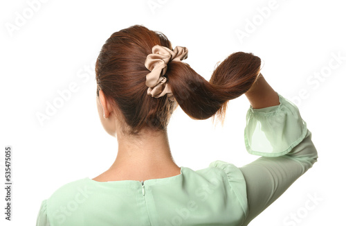 Woman with ponytail and silk scrunchy on white background