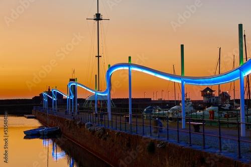 Whitehaven Wave lit up at sunset on Whitehaven harbor's Lime Tongue, England