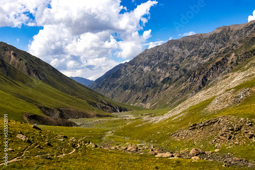 Beautiful mountain scenery. River, valley, snow, blue sky, white clouds. In-depth trip on the Sonamarg Hill Trek in Jammu and Kashmir, India