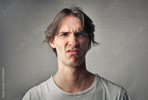 portrait of young man with disgusted expression