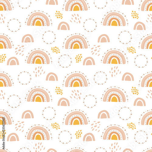 Cute rainbows in boho style. Doodle seamless pattern with abstract elements. Pastel beige and yellow colors. Vector background for cards and children illustrations, kids bedroom or preschool.