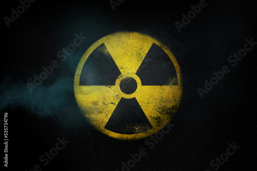 Nuclear energy radioactive round yellow symbol on asphalt texture