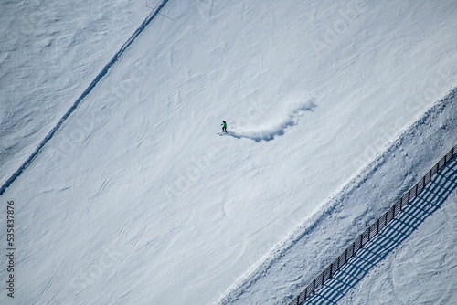 Aerial view of a man skiing on the mountain snow