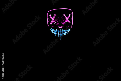 Purple and blue Halloween led mask with black background 