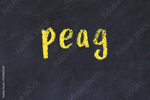 College chalk desk with the word peag written on in