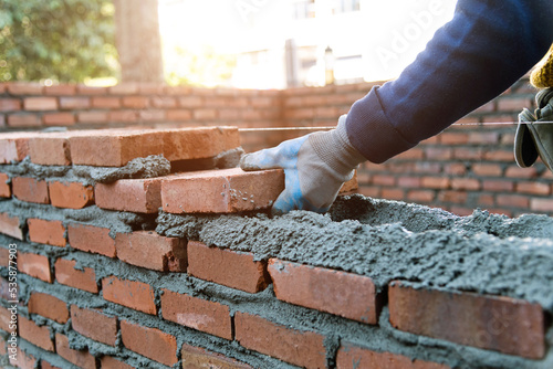 Close up of bricklayer building walls