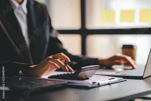 Portrait of a woman working on a tablet computer in a modern office. Make an account analysis report. real estate investment information financial and tax system concepts