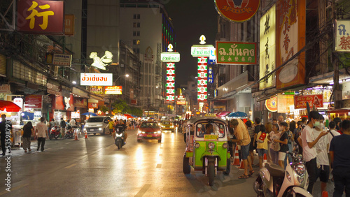 Night market at Yaowarat road, Bangkok City, Thailand. The famous tourist attraction with full of advertising Chinese signs. Cars of tourists people with billboard. China town. Walking street.