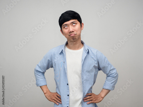 Asian man posing hands at waist feels jealous at his face isolated