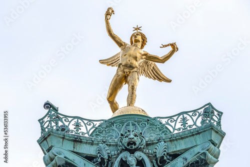 Fragments of July Column (Colonne de Juillet, 1840) with Genie de La Liberty at top on Place de la Bastille. Paris, France.