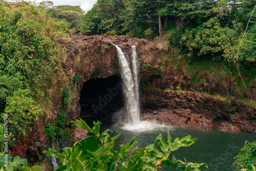 water falls in hawaii rush over a cliff in a tropical environment. 
