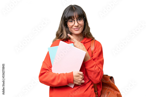 Young student caucasian woman over isolated background pointing to the side to present a product