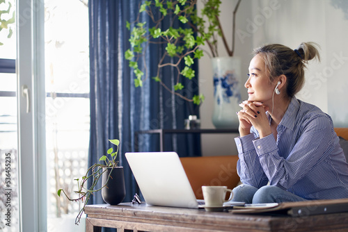 mature asian woman working from home using notebook computer