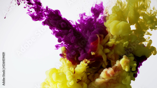 Abstract formed purple, yellow color dissolving water. Abstract cloud ink swirling water. High-quality stock photo Acrylic ink underwater form, abstract smoke pattern isolated on white background