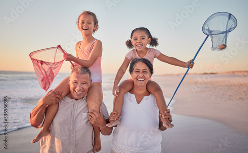 Children, grandparents and fishing with a family on the beach during summer for holiday, vacation or travel. Kids, happy and ocean with a senior man, woman and their grandkids by the sea at sunset