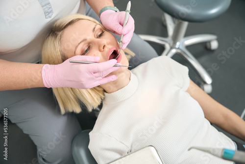 Lady with white hair sits in the dentist's chair