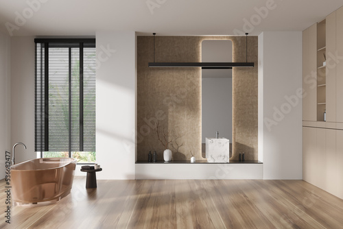 Light bathroom interior with bathtub and sink, accessories and window