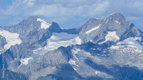 The landscape of the Swiss Alps, with the highest peaks and glaciers of the canton of Valais viewed from the Simplon Pass, Switzerland - July 2022.