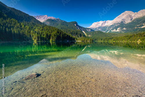 Lake Tovel reflection symmetry in Trentino-Alto Adige, Dolomites, Italy