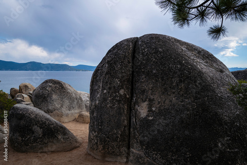 Big glacial boulders and rocks on the lake Tahoe beach on a cloudy day in Sand Harbor in Nevada