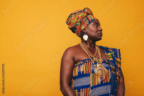 Stylish African woman wearing a cultural attire in a studio