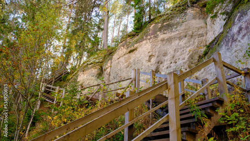 The large sandstone cliffs of Sietiniezis on the banks of the Gauja River in Latvia. tourist nature trail for hiking with wooden stairs. Gauja National Park in the vicinity of Valmiera, Autumn, 