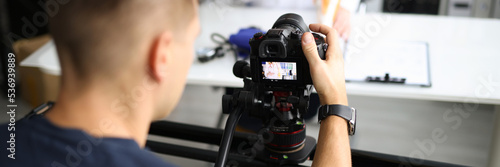 Blogger shooting video on professional camera in studio closeup