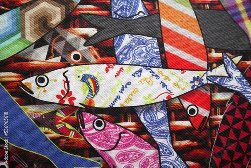 Close up sardine in traditional portuguese fabric from Minho in a sea of colorful sardines