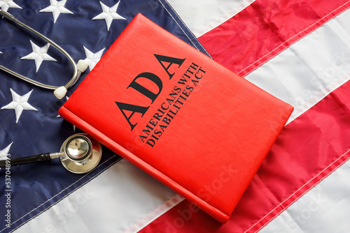 American flag, book The Americans with Disabilities Act ADA law and stethoscope.