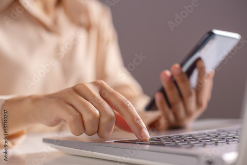 Woman hand enter a one time password for the validation process on laptop, Mobile OTP secure Verification Method, 2-Step authentication web page, Concept cyber security safe data protection business.