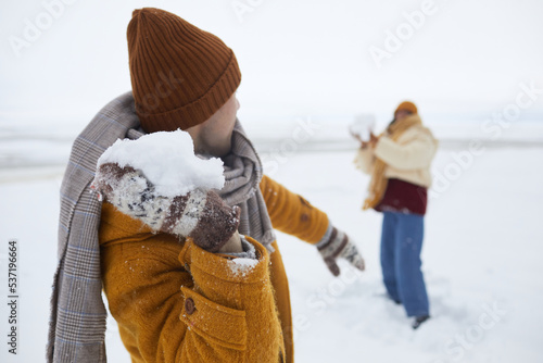 Close up of couple playing snowball fight outdoors in winter, copy space