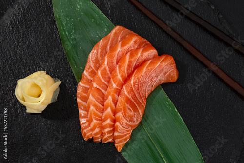 Japanese food style, Top view of salmon slice on bamboo leaves, Salmon sashimi is Japanese traditional, Selective focus, Fish slices top view