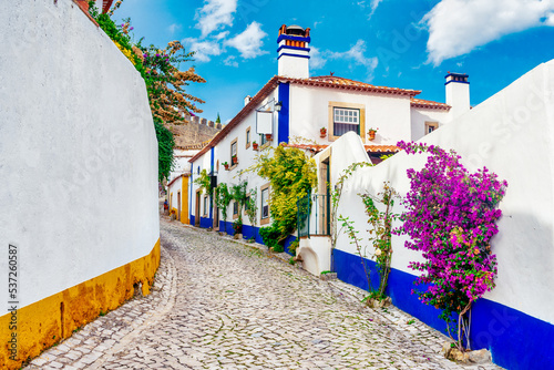 Typical street of the medieval village of Óbidos in Portugal .