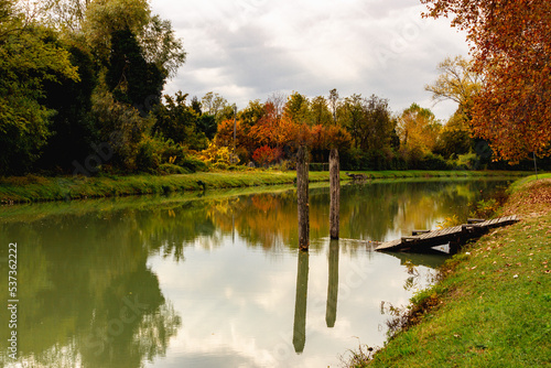 Scenic landscape of the Riviera del Brenta. Beautiful autumn image. Canal with reflection of the trees. Relaxation and meditation concept. Dolo, Italy.