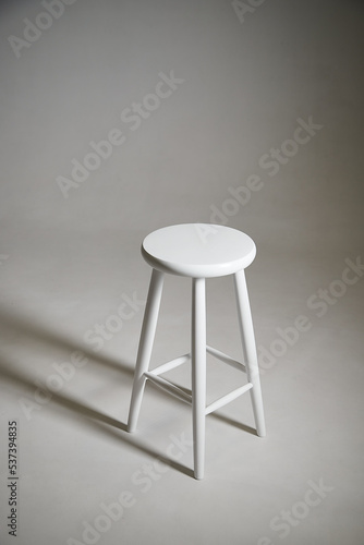 White stool with shadow on white background. Location in studio with tabouret on white background