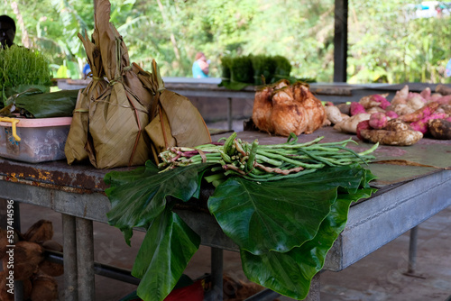 Local produce of leafy greens, sweet potatoes, drinking coconuts on a small fruit and vegetable market stall in Panguna Mine, Bougainville, Papua New Guinea